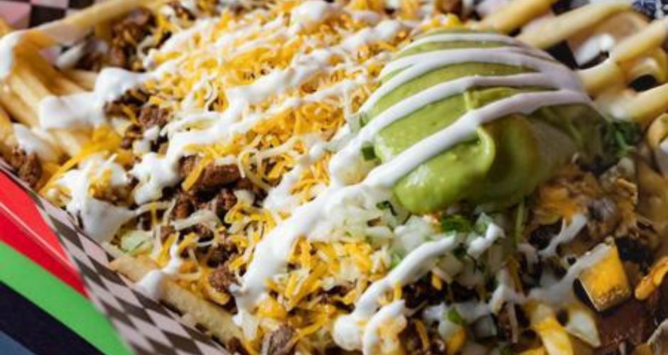 Cali fries from Calitacos. Fries covered in ground meat, melted cheese, onion, cilantro, sour cream, and guacamole.